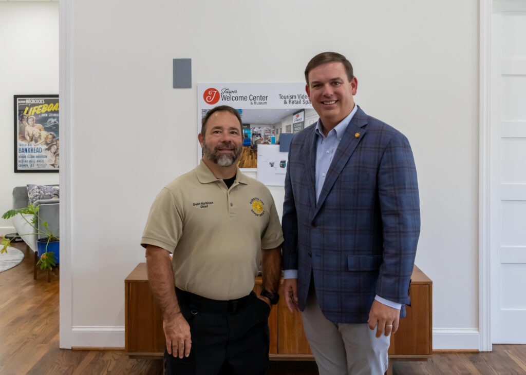 Sen. Matt Woods poses with Chief Dean Harbison at the front of the Jasper Main Street Welcome Center