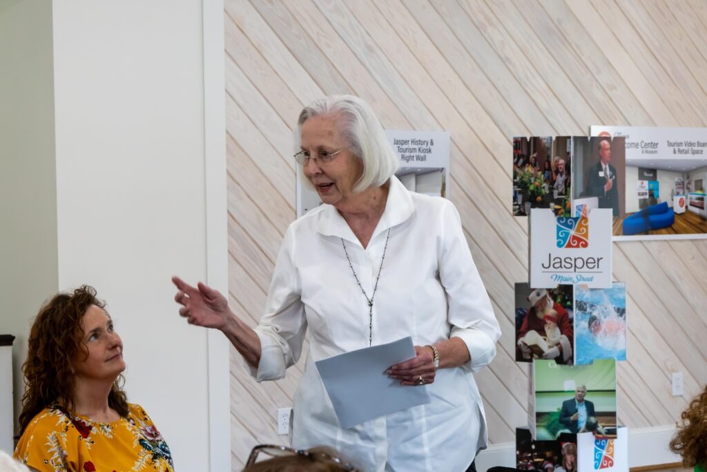 Close-up of Carol Downs speaking with a paper in her hand