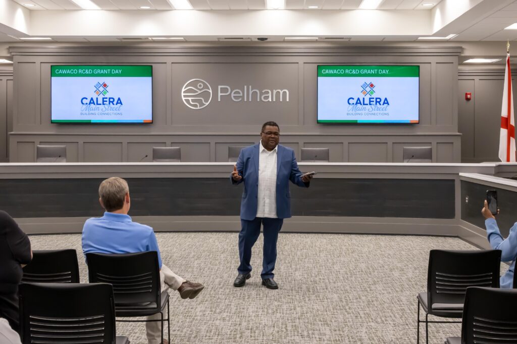 Markus Snowden stands at the front of the room and talks about Calera Main Street’s project 