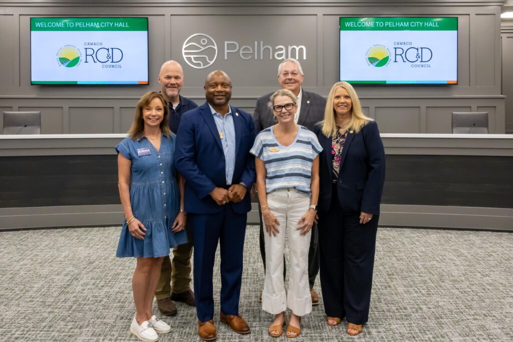A representative from Ady's BiG Army stands with Shelby County legislators at the grant presentation ceremony, posing at the front of Pelham City Council Chambers