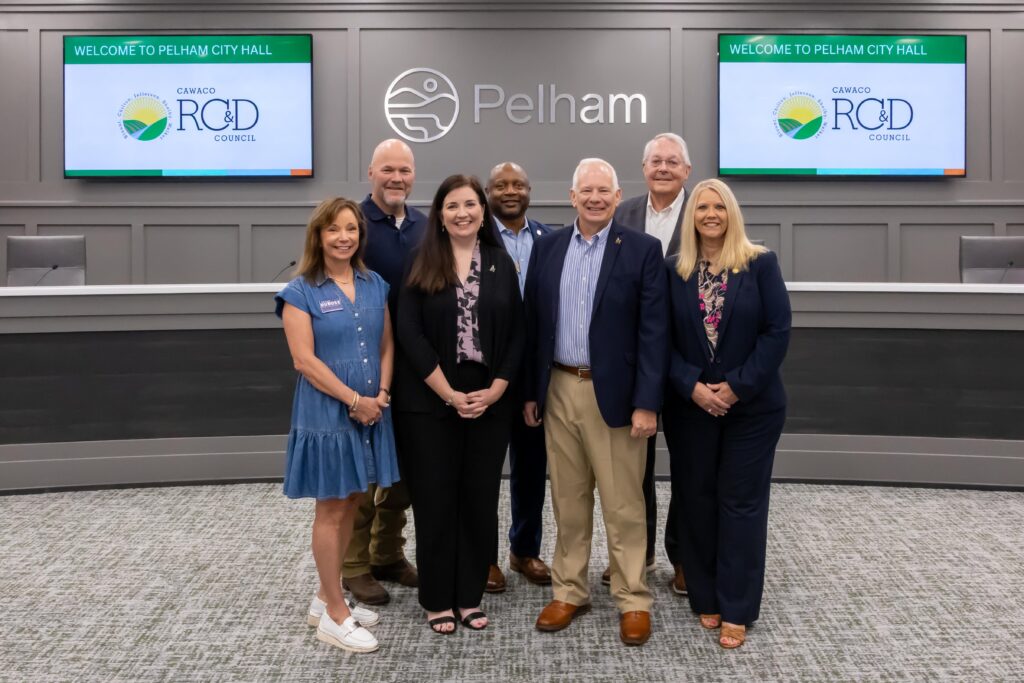 Representatives from University of Montevallo Foundation stand with Shelby County legislators at the grant presentation ceremony, posing at the front of Pelham City Council Chambers
