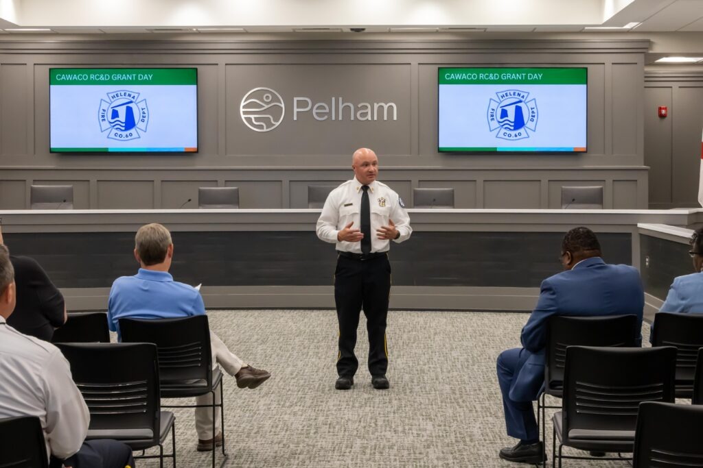 Chief Chris Miller stands at the front of the room and talks about Helena Fire Department's project 