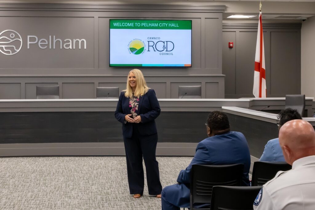 Sen. April Weaver stands at the front of the Pelham City Council Chambers and speaks to the crowd