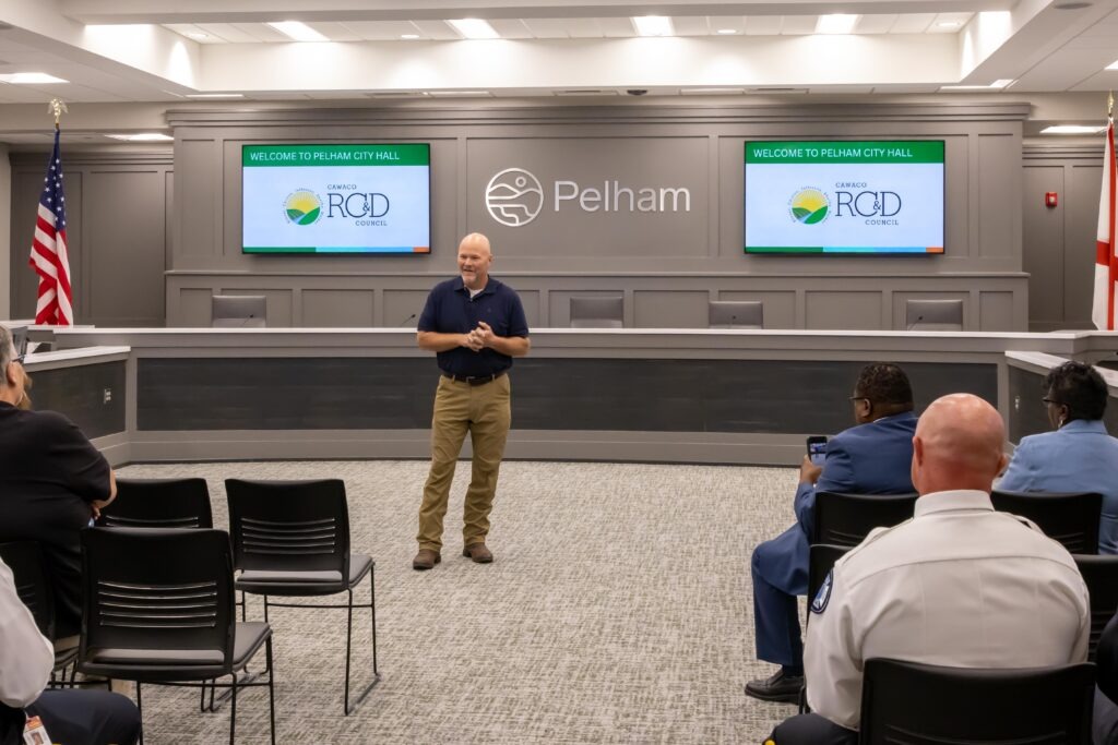 Re[. Corley Ellis stands at the front of the Pelham City Council Chambers and speaks to the crowd