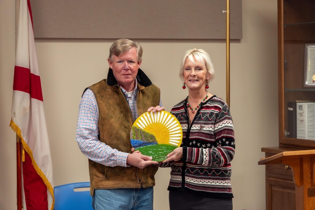 Patti presents the Outstanding Board Member Award to Keith Pike. The award is a glass replica of the RC&D mark.