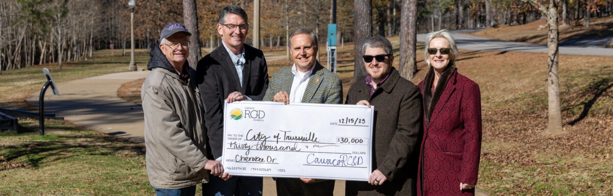 Novelty check presentation in front of a sidewalk along Cahaba River trail system