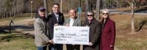 Novelty check presentation in front of a sidewalk along Cahaba River trail system