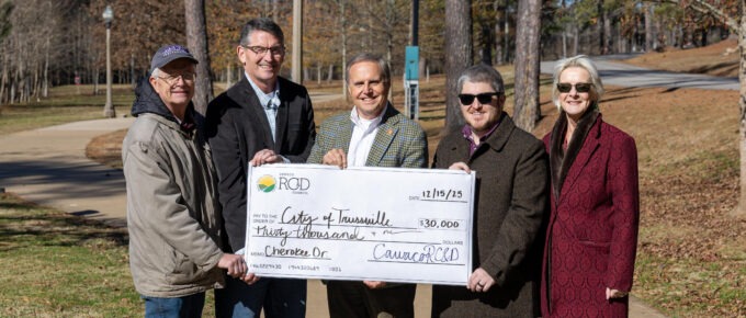 Novelty check presentation in front of a sidewalk along Cahaba River trail system