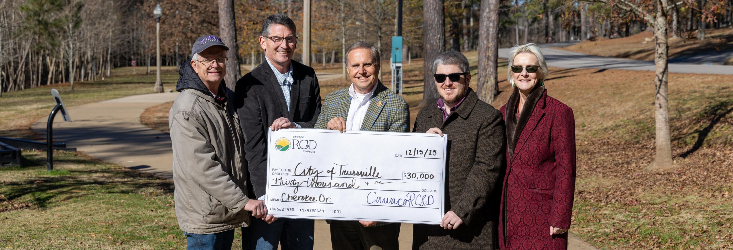 Novelty check presentation in front of a sidewalk along Cahaba River trail system