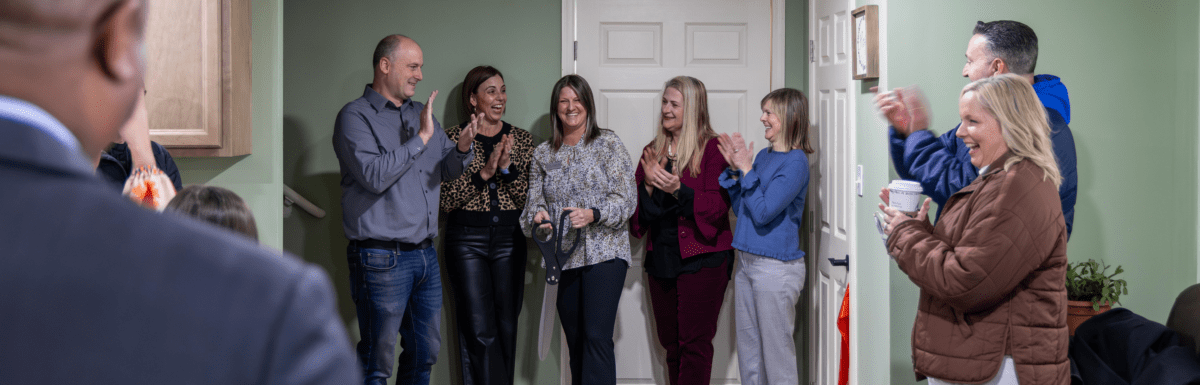 RPP Executive Director and board smile and applaud immediately after ED cut the ribbon, officially opening the facility