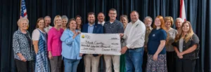 Representatives of Cawaco RC&D, the Blount County Legislative Delegation, and grant recipients stand on stage holding a large ceremonial check for $152,456 made out to Blount County for 2026 grants.
